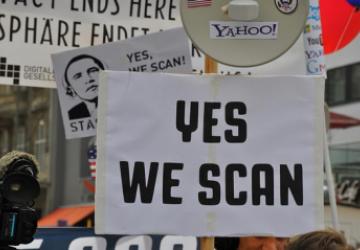 Protesters with "Yes we scan" sign